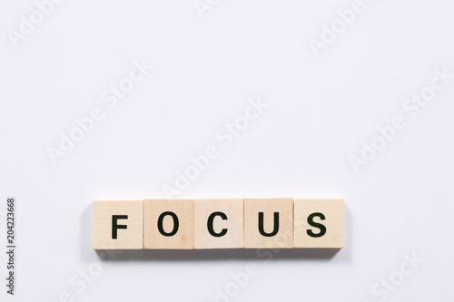 word focus made of wooden block isolated on white background