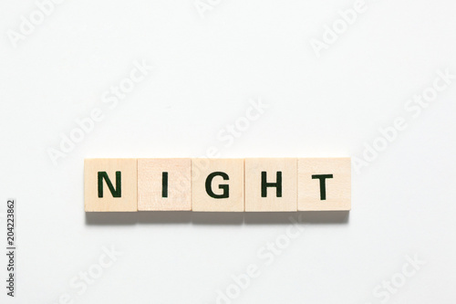 word inight made of wooden block isolated on white background