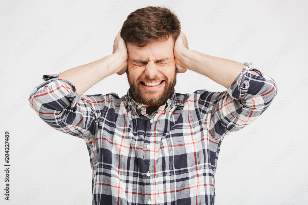 Portrait of a depressed young man in plaid shirt Portrait of a depressed young man in plaid shirt