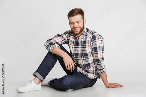 Portrait of a smiling young man in plaid shirt