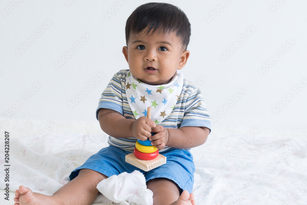 Cute asian baby sitting and play wooden toys Cute asian baby sitting and play wooden toys