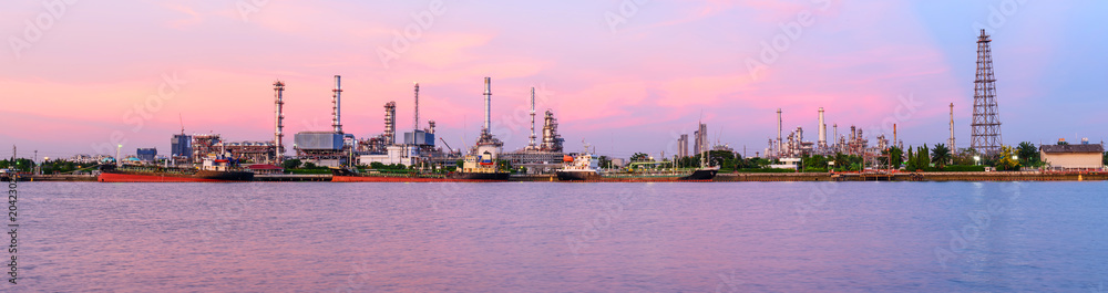 Panorama view of Oil refinery at the river in sunset time