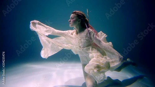 Wallpaper Mural tranquil graceful woman is floating slowly near bottom of sea and sun is shining on her figure Torontodigital.ca