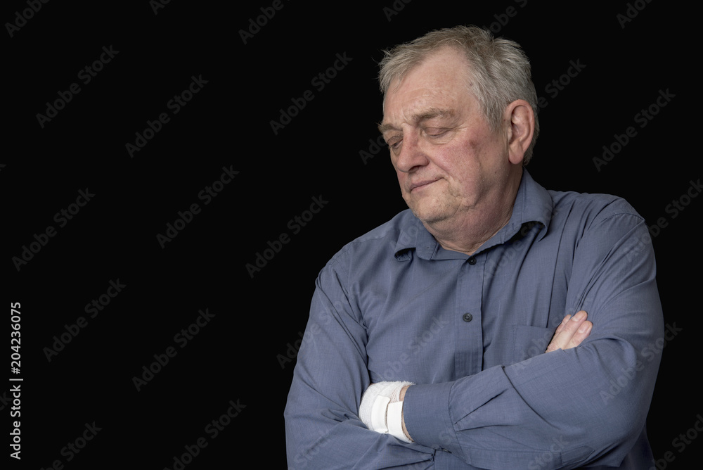 Mature man looking bored and fed up, taken on a black background Mature man looking bored and fed up, taken on a black background