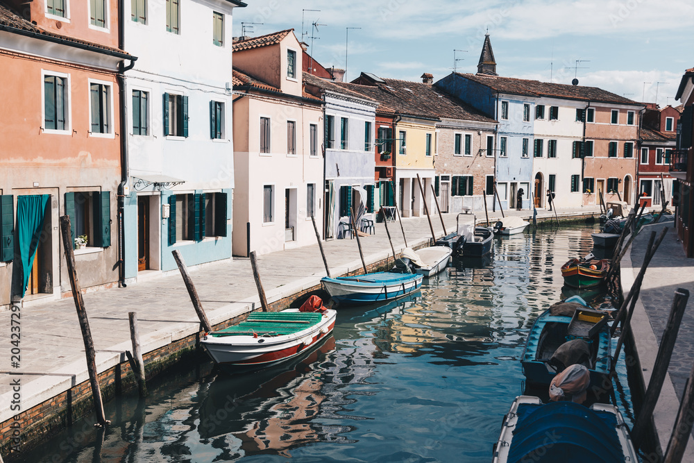 View of Burano with traditional colorful houses and reflection in the water