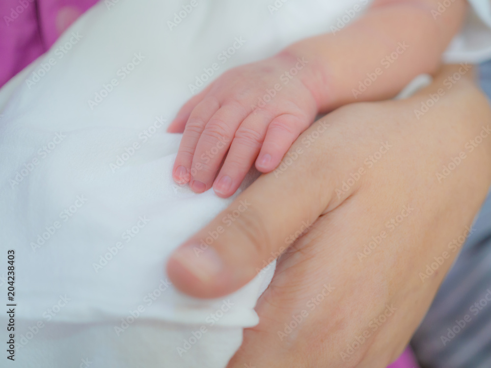 mother day and new born concept from mother's hand hold with small baby foot and hand with soft focus background mother day and new born concept from mother's hand hold with small baby foot and hand with soft focus background