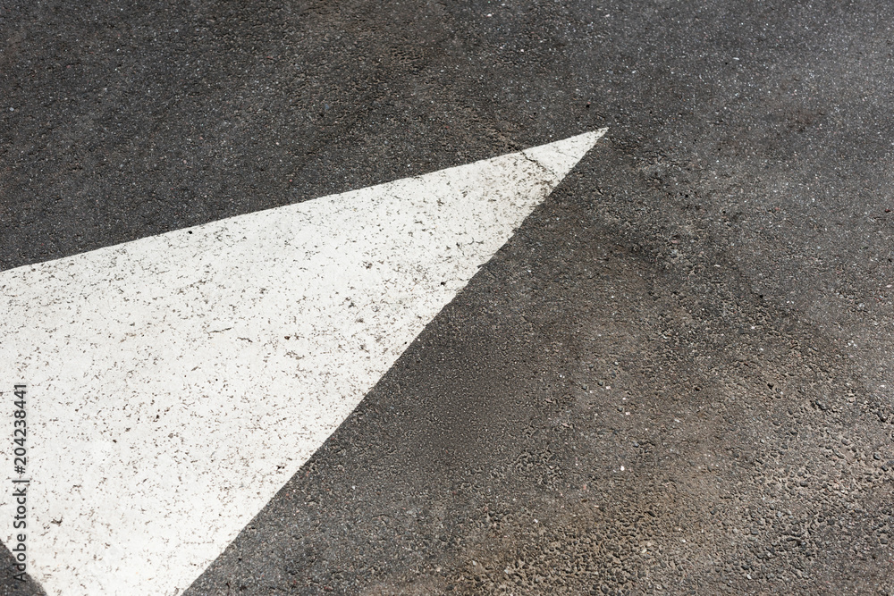 Fototapeta premium White painted arrow on asphalt road