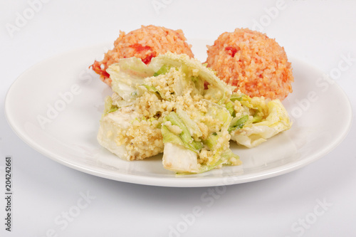 Tomato rice and salad on a white