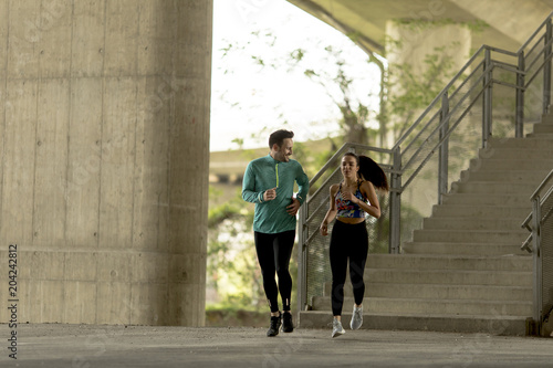 Young couple running in urban enviroment