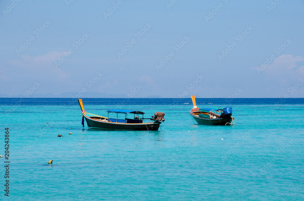 Turquoise sea And blue sky White Sand Beach with two taxi long tail boat, travel concept. Koh Lipe, Satun, Thailand