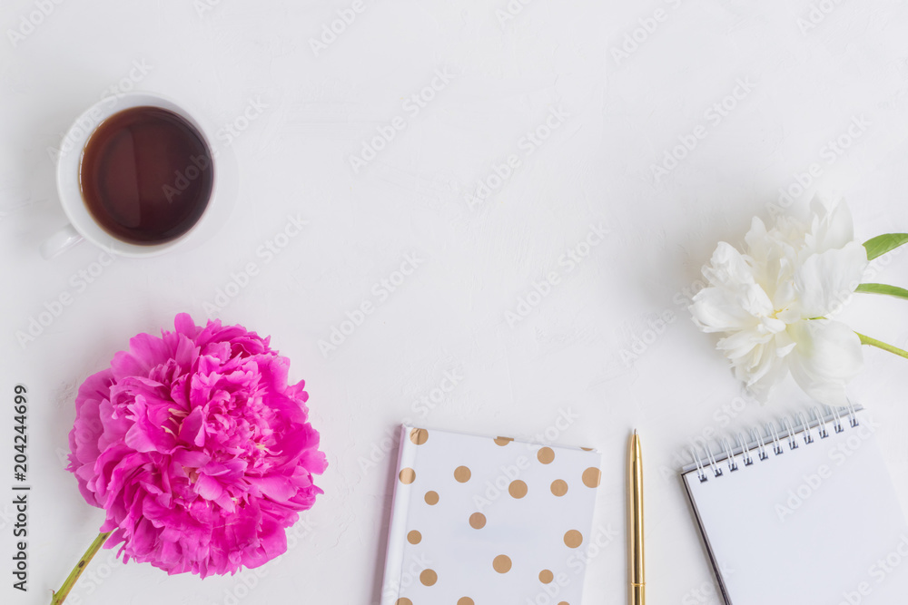 Flat lay desk with pink peony, gold notebook and accessories Flat lay desk with pink peony, gold notebook and accessories