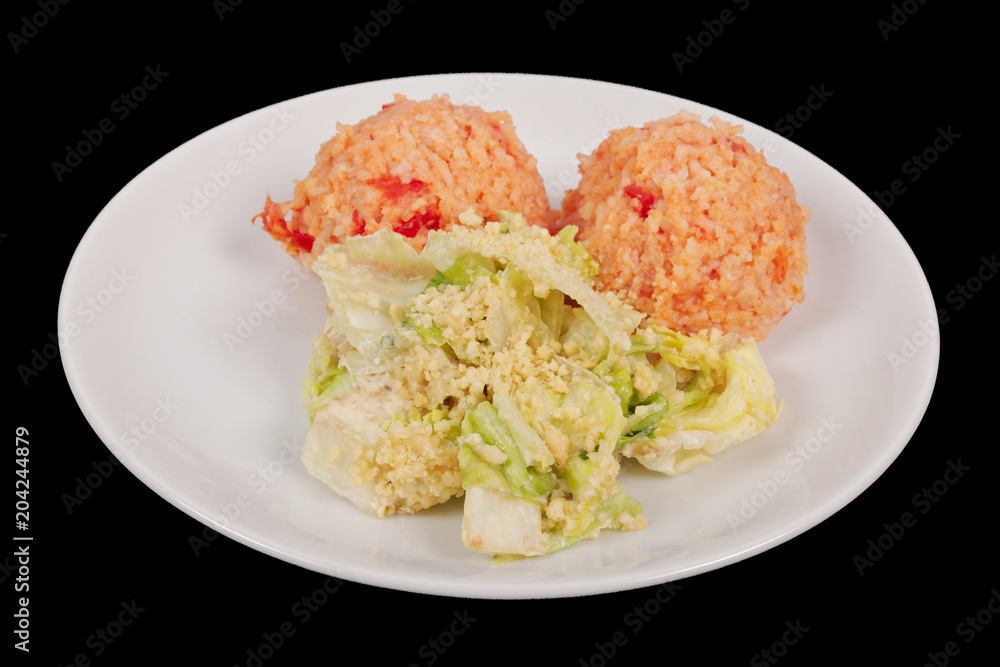 Tomato rice and salad on a black Tomato rice and salad on a black