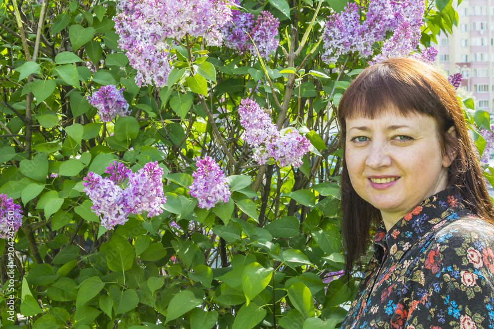 Girl on the background of a lilac tree of spring Girl on the background of a lilac tree of spring