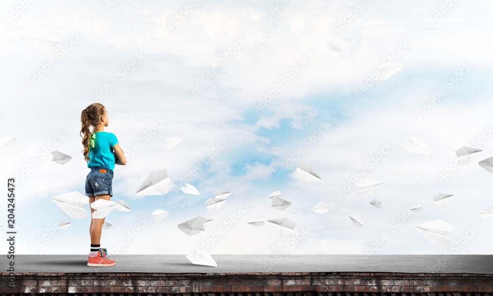 Concept of careless happy childhood with girl looking far away Concept of careless happy childhood with girl looking far away