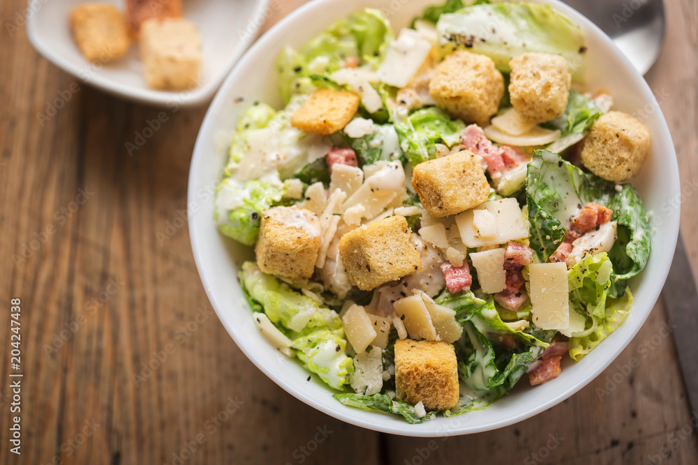 Chicken Caesar salad with bacon, parmesan and croutons Chicken Caesar salad with bacon, parmesan and croutons