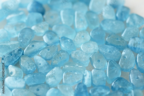 Aquamarine is blue. Natural stone is blue aquamarine. The background is aquamarine. Place for text. Card photo