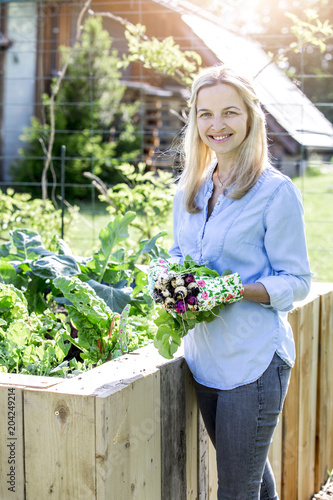 Woman is holding fresh bio radishes in her hands