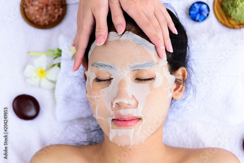 Portrait of beautiful asian people has masking with close up view and close up eyes and having hand massage in spa salon. Beauty, healthy, spa and relaxation concept.