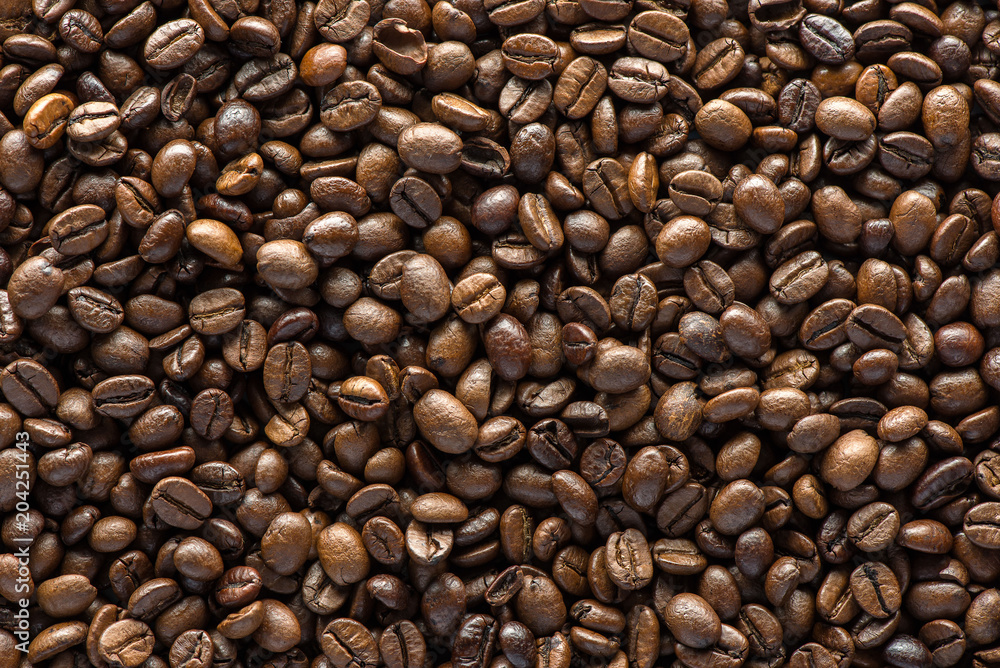 Roasted coffee beans on texture background.