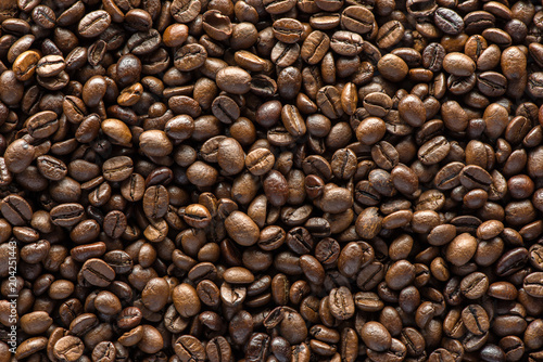 Roasted coffee beans on texture background.