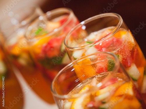 Selective focus of glasses full of champagne with fruit