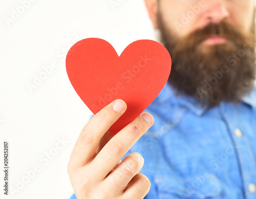 Card in heart shape in hand of bearded hipster