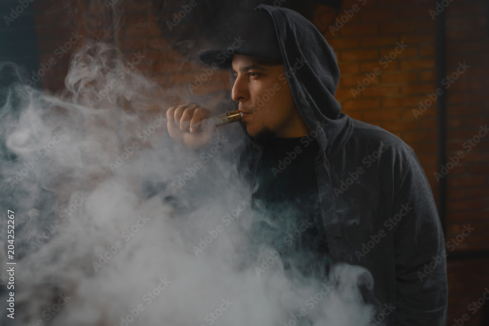 Man in a cloud of white vapour fume