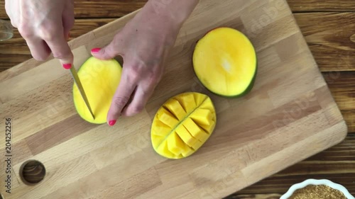Woman prepare mango for smoothie, top view video photo