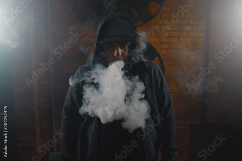 Man in a cloud of white vapour fume