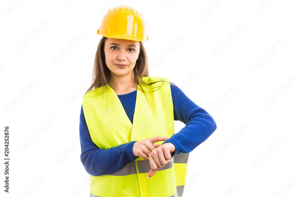 Young female engineer making late time gesture. Young female engineer making late time gesture.