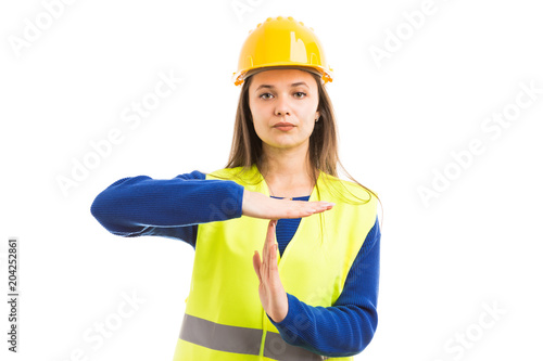 Young female engineer making time out gesture.