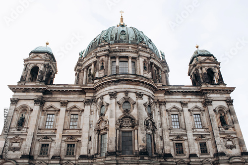 The Berlin Cathedral is called Berliner Dom. Beautiful old building in the style of neoclassicism and baroque with cross and sculptures.