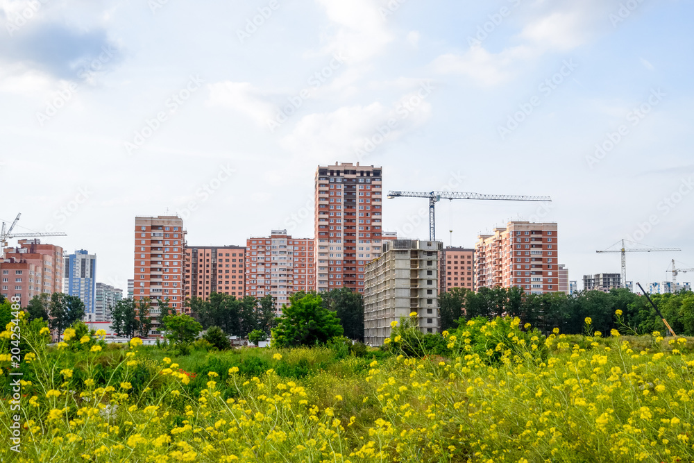 Fototapeta premium New storey residential building on the city street. Residential houses