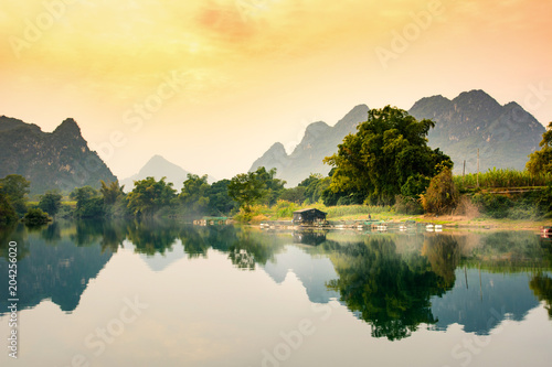 Canvas Print Sunset over a lake in Guangxi province of China
