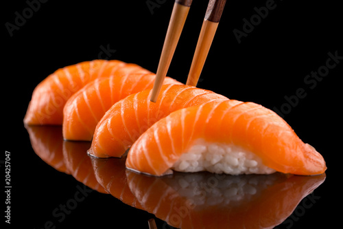 salmon nigiri sushi on the black background