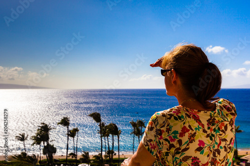 Woman looking for whales on Maui