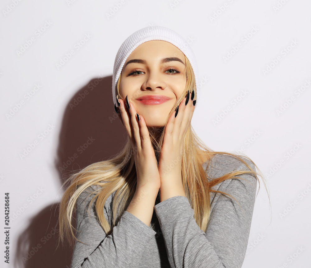 Lifestyle and people concept: Young cute smiling hipster girl wearing white glasses and hat. Emotion on face. Lifestyle and people concept: Young cute smiling hipster girl wearing white glasses and hat. Emotion on face.