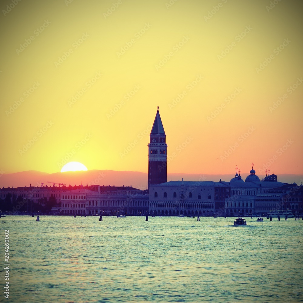 SUNSET in VENICE in Italy and the Campanile of St. Mark with vintage effect