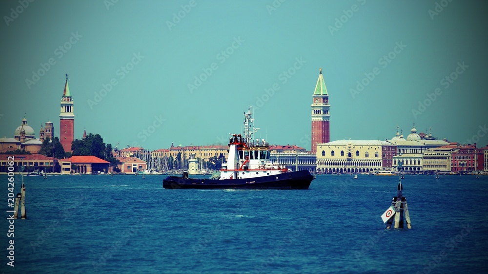 tugboat for cruise ships sailing to the port of Venice with vintage effect