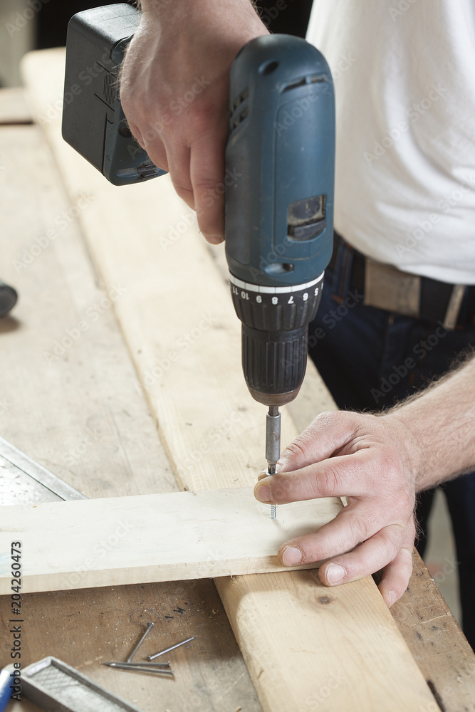 carpenter using electric drill carpenter using electric drill