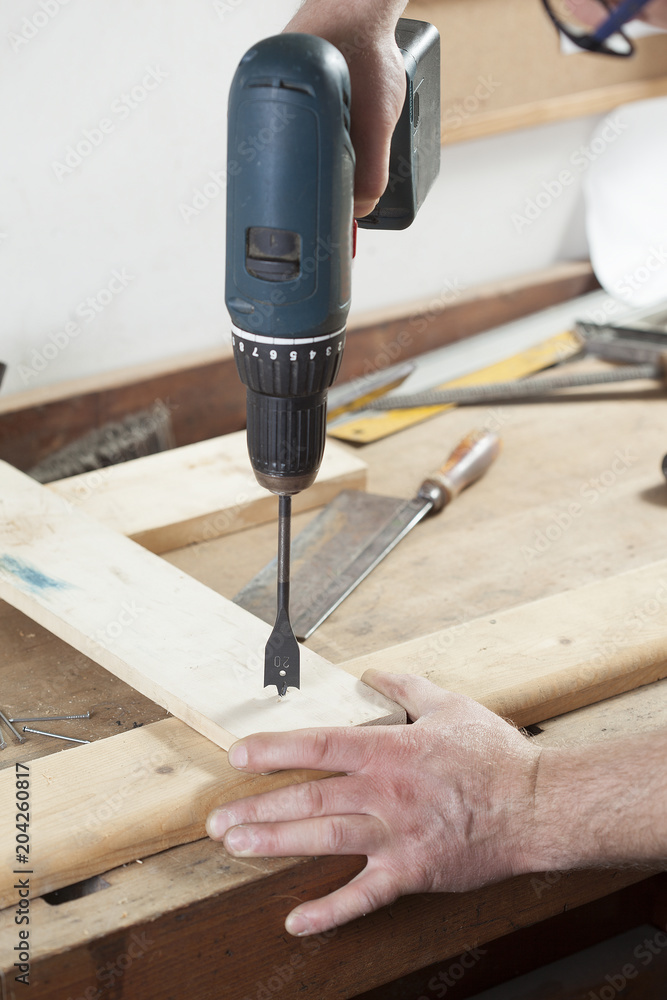 carpenter using electric drill carpenter using electric drill