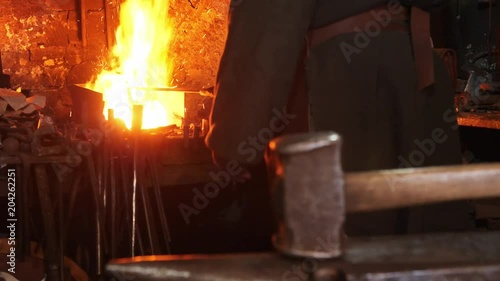 Close-up of a hammer against the background of a blacksmith working near a bugle photo