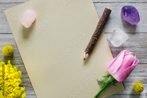 Blank Paper with Pencil, Flowers and Stones photo