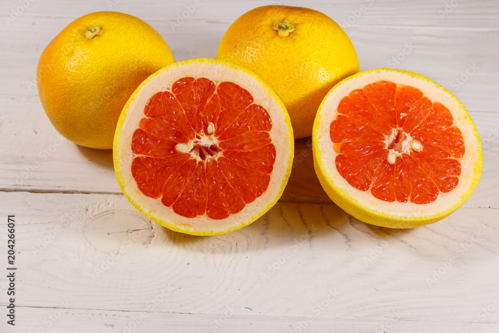 Ripe fresh grapefruits on white wooden table Ripe fresh grapefruits on white wooden table