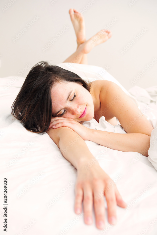brunette young woman lying in bed and sleeping brunette young woman lying in bed and sleeping