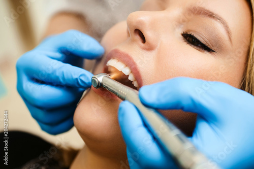 Close-up of dental drill use for patient teeth in dentistry office in a dental treatment procedure