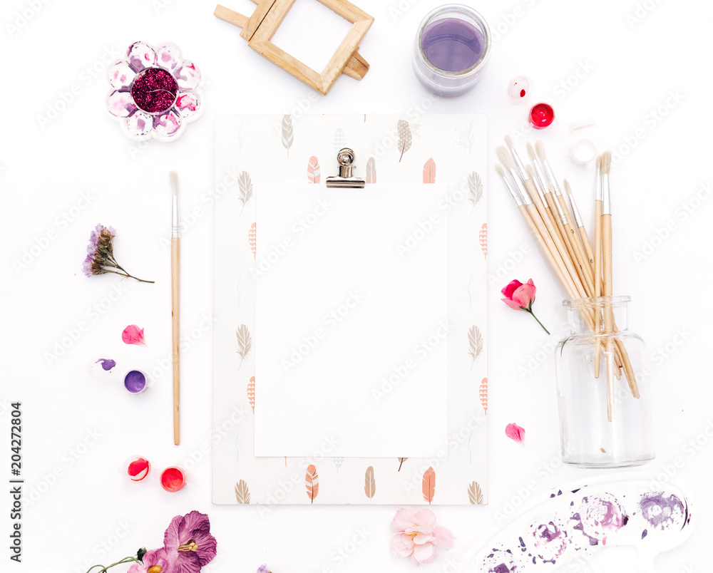 Art workspace. Paint brushes and clipboard on white background. Flat lay Top view, copy space Art workspace. Paint brushes and clipboard on white background. Flat lay Top view, copy space