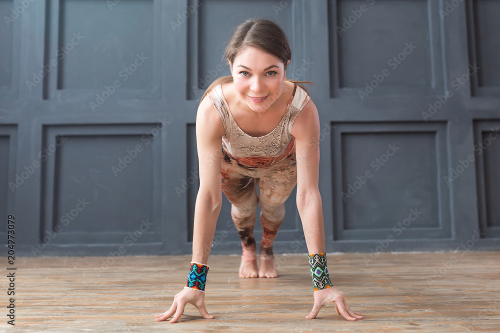Young attractive woman practicing yoga in studio. Wellness, calmness relax concept.