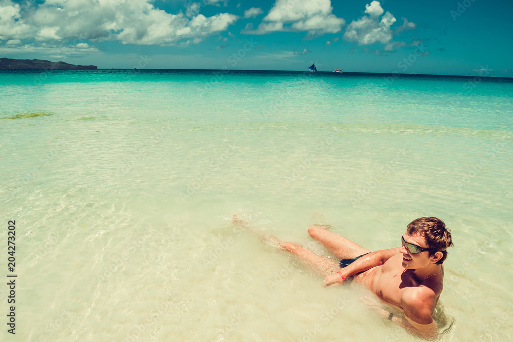 Happy man in swimming goggles relax in sea enjoying summer beach vacation. Time to travel. Stress free. Crystal clear water. Exotic luxury holiday. Healthy lifestyle concept. Copy space. Body care.