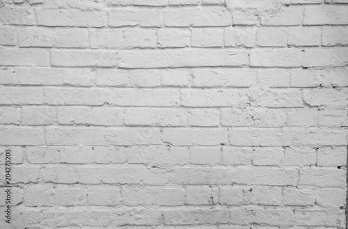 old wall from a white brick with a regular laying. horizontal direction